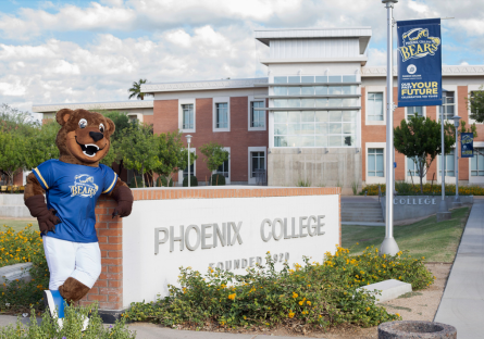 Phoenix College campus - Bumstead mascot standing next to PC sign outside by Fannin Library
