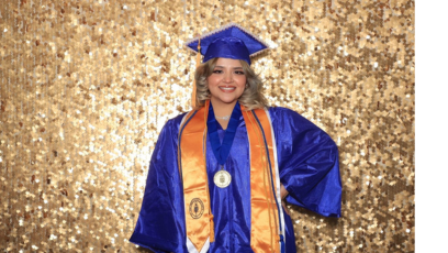 PC graduate, Ingrid in blue and gold Commencement regalia