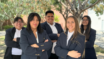 PC United Executive Board (5 students in navy blazers standing outside)