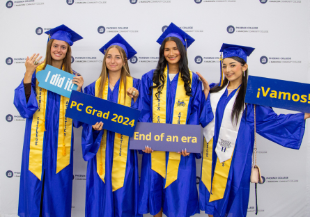 Phoenix College graduates posing for pictures in their blue caps and gowns at their 2024 Commencement